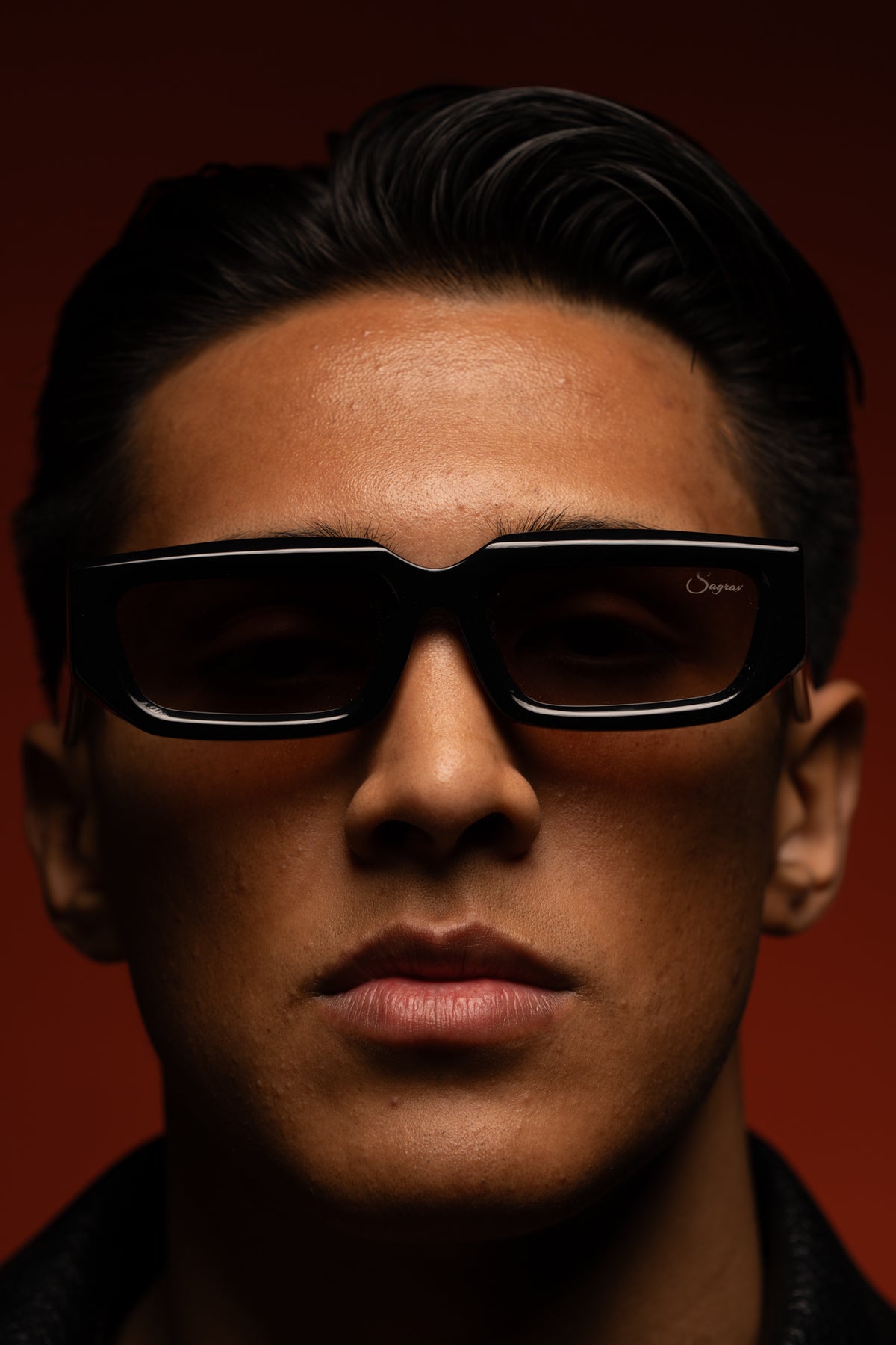 Emiliano wearing The Fortress with red-tinted lenses against the original red background