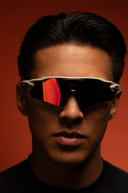 Emiliano wearing vanguard sunglasses against original red background